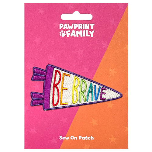 Rainbow coloured Be Brave pennant patch on a pink and orange backing card Pawprint Family Whirligig Toys