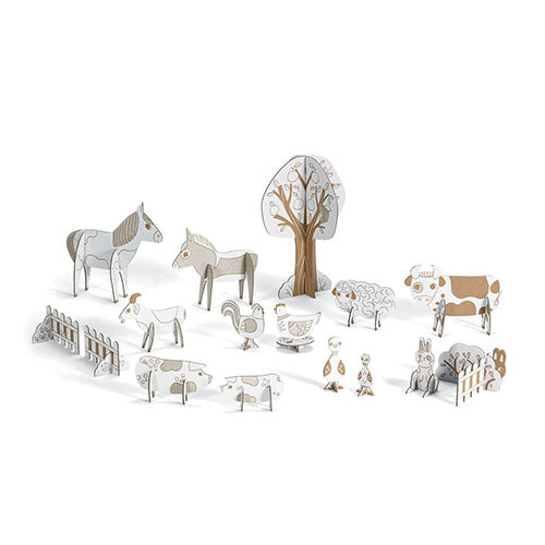Set of cardboard animals and trees on a white background